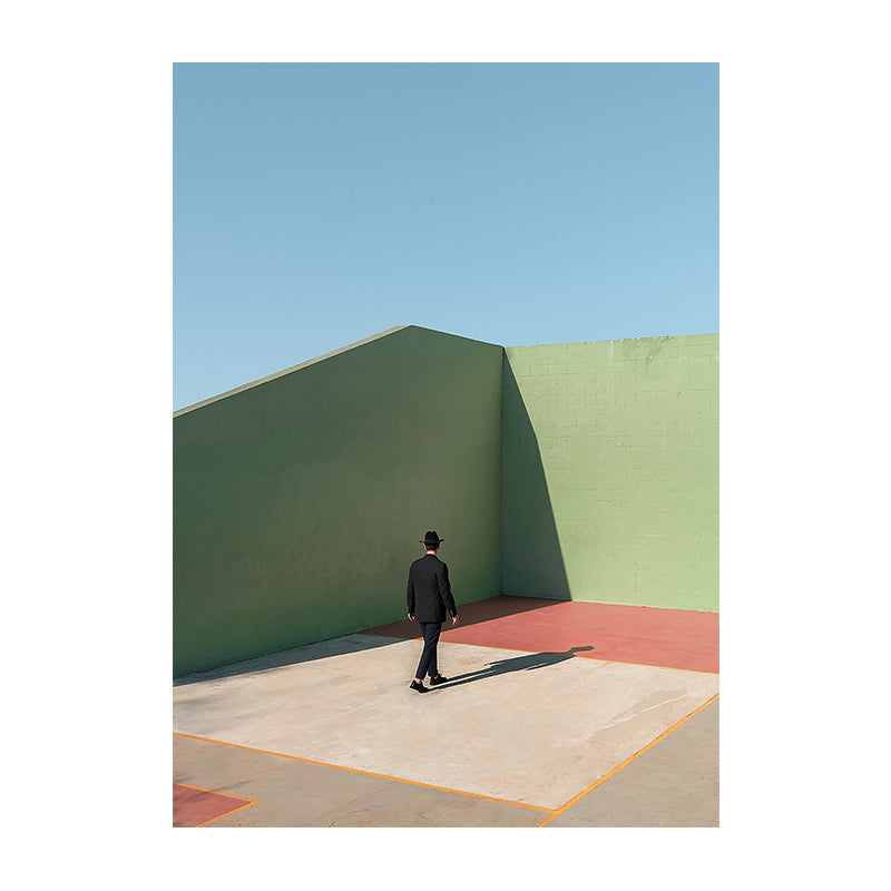Man in Hat on Green Wall